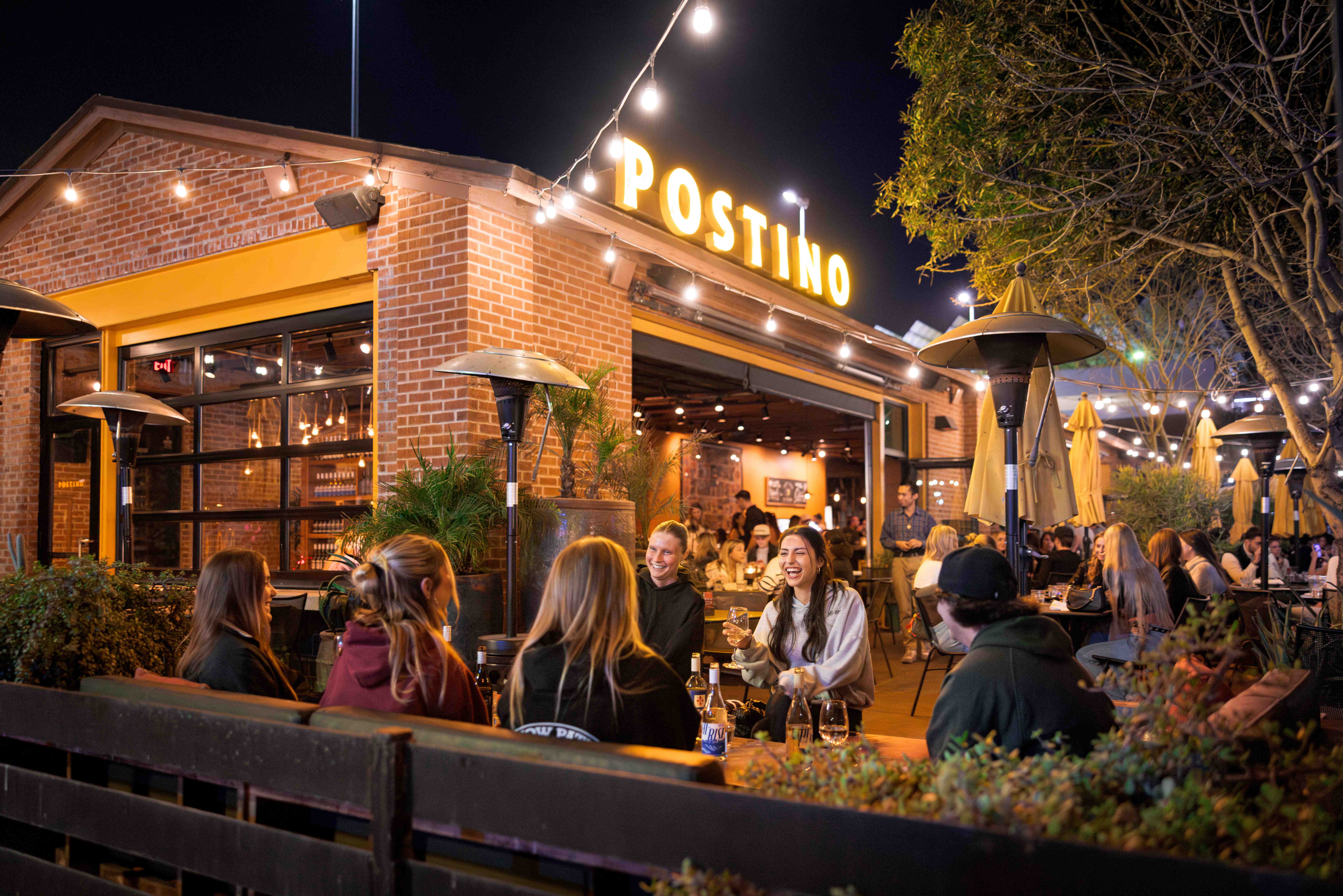 Friends enjoying wine and bruschetta boards at Postino Annex in Tempe, Arizona Group of friends enjoying wine and bruschetta boards at Postino Annex in Tempe