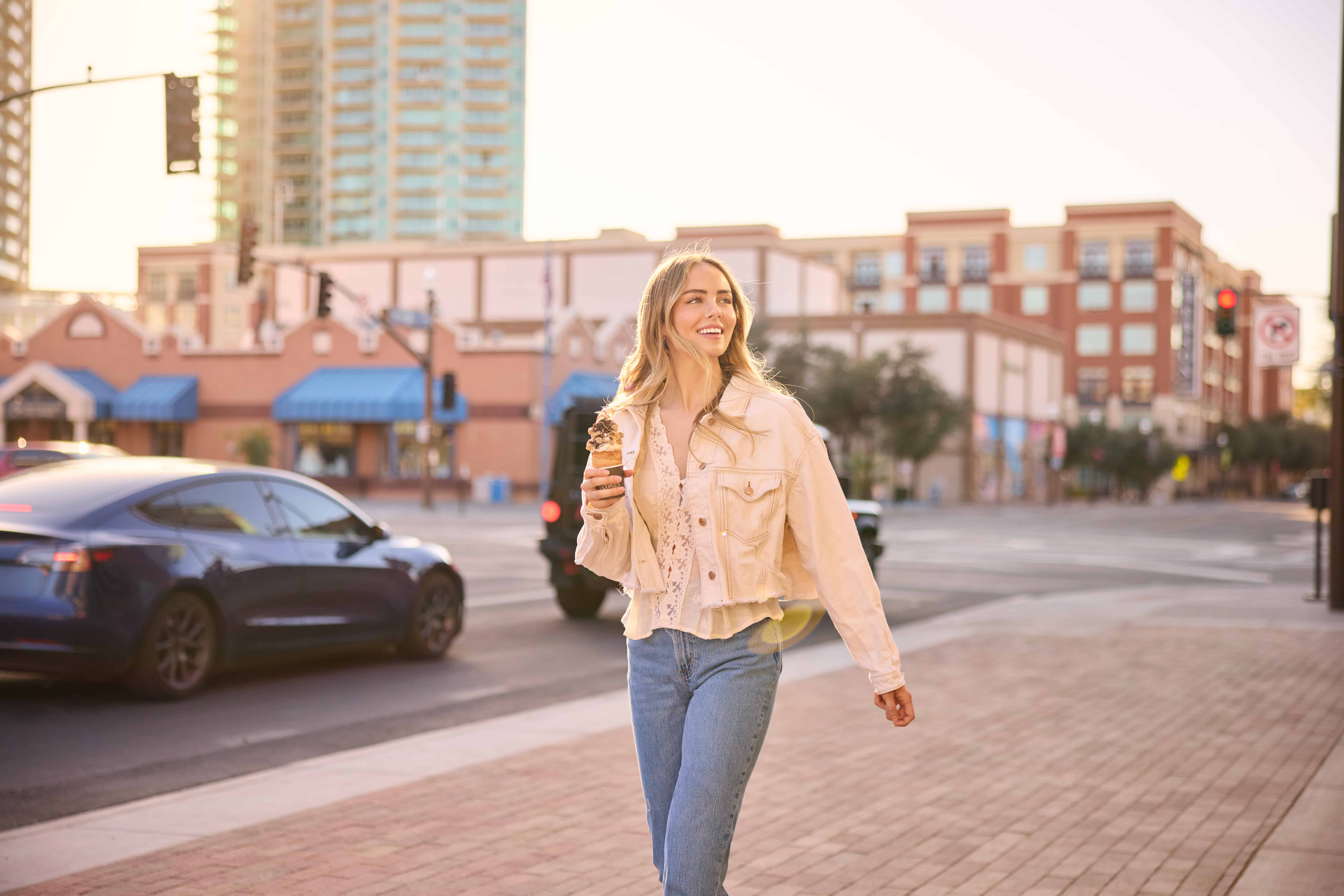Young woman with ice cream cone walking Mill Avenue, Tempe, Arizona Young woman walking on Mill Avenue in downtown Tempe with an ice cream cone